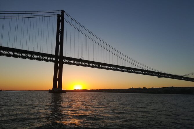 Lisbon: Sunset Sailing with Portuguese Wine and History - Cristo Rei across the Tagus